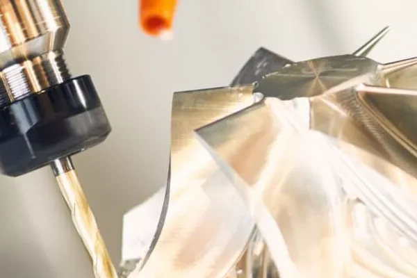 4 Axis CNC Machining: How It Works, Benefits & Applications 1 Zoomed-in shot of 4-axis CNC milling, showing the tool and rotating fixture working together to achieve high-precision cuts and complex geometries.