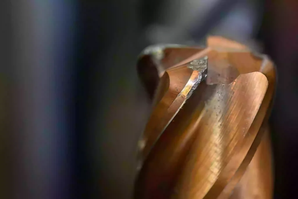 The Ultimate Guide to Brass CNC Machining 3 Close-up of milling tool coating wear in brass CNC machining, showing tool wear challenges and the importance of proper tool selection for precision parts.