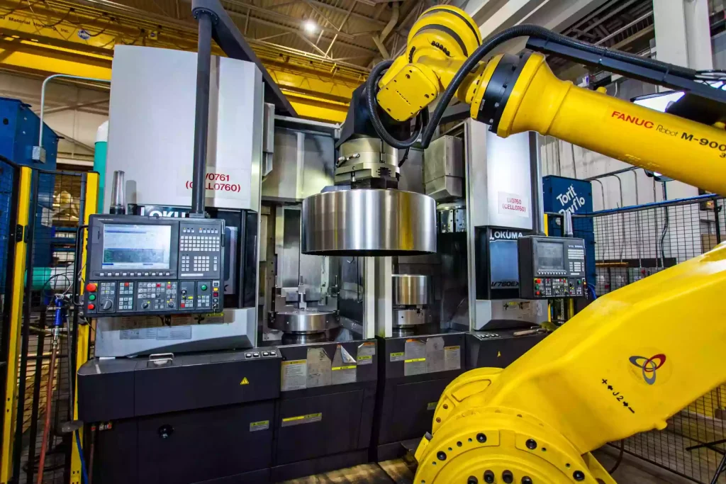 Robotic CNC Machining: Automation for Precision & Efficiency 1 Industrial robotic arm operating a CNC machine for automated precision machining
