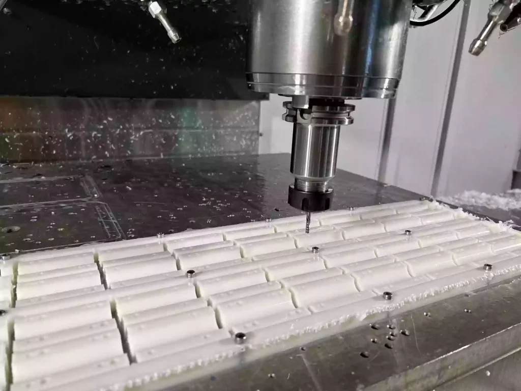 What is PBT CNC Machining? 1 This is a process flow chart for PBT CNC machining, illustrating how a CNC machine cuts a block of polybutylene terephthalate (PBT) plastic into a custom-engineered component.